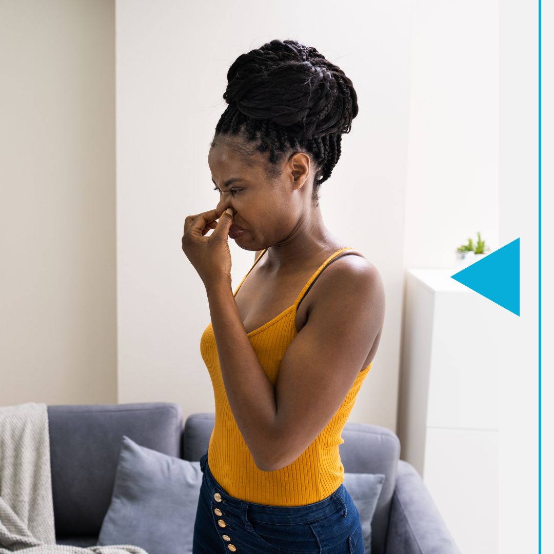 Image of a woman smelling something bad